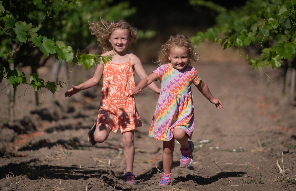 The Pease children playing in a vineyard